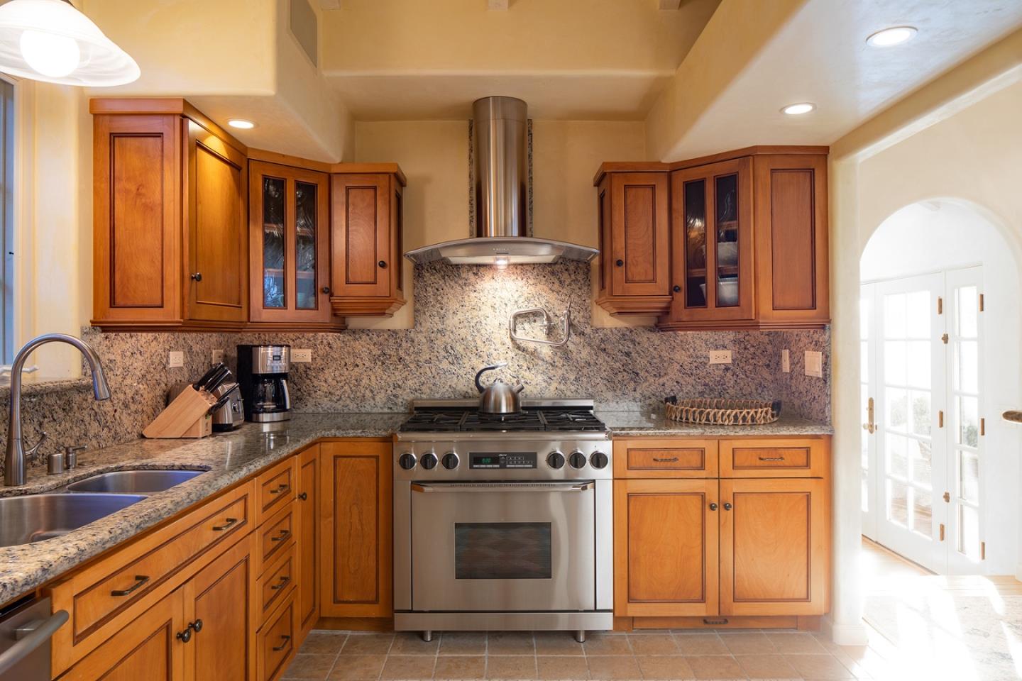 26335 Rio Avenue Carmel, CA 93923 - Photo 5 of 13 a kitchen with stainless steel appliances granite countertop a stove and a sink