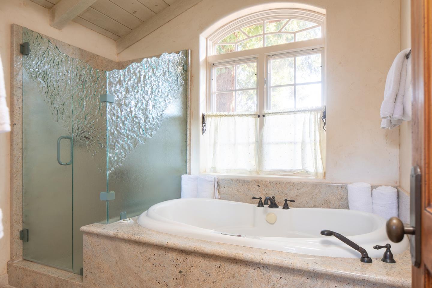 26335 Rio Avenue Carmel, CA 93923 - Photo 10 of 13 a bathroom with a bathtub and a shower