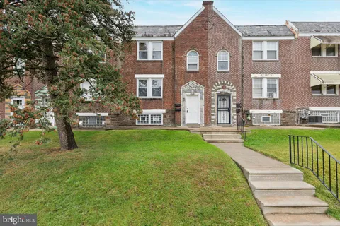 a front view of a house with a yard table and chairs