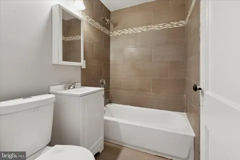 a bathroom with a sink mirror vanity and toilet