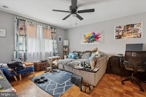 a living room with furniture a couch and a chandelier