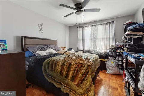 a bed sitting in a bedroom next to a window