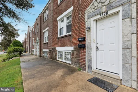 a view of a house with a door and wooden walls