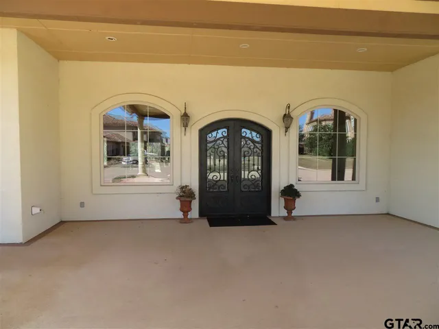 a view of a dining room with furniture and chandelier fan