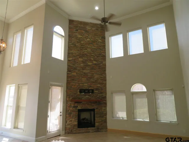 a view of a livingroom with a fireplace and window