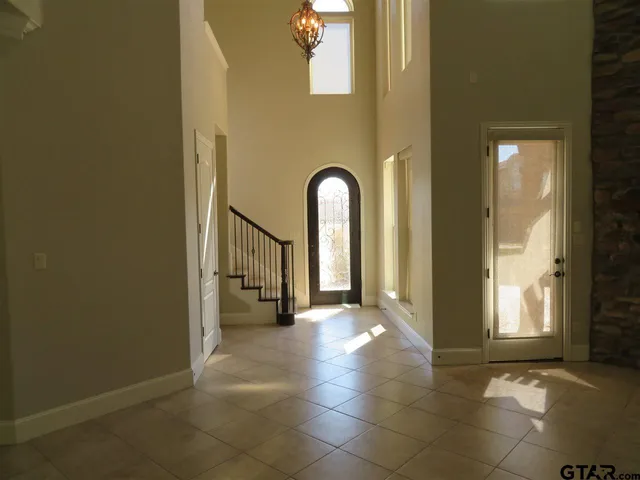 a view of a hallway with wooden shelves