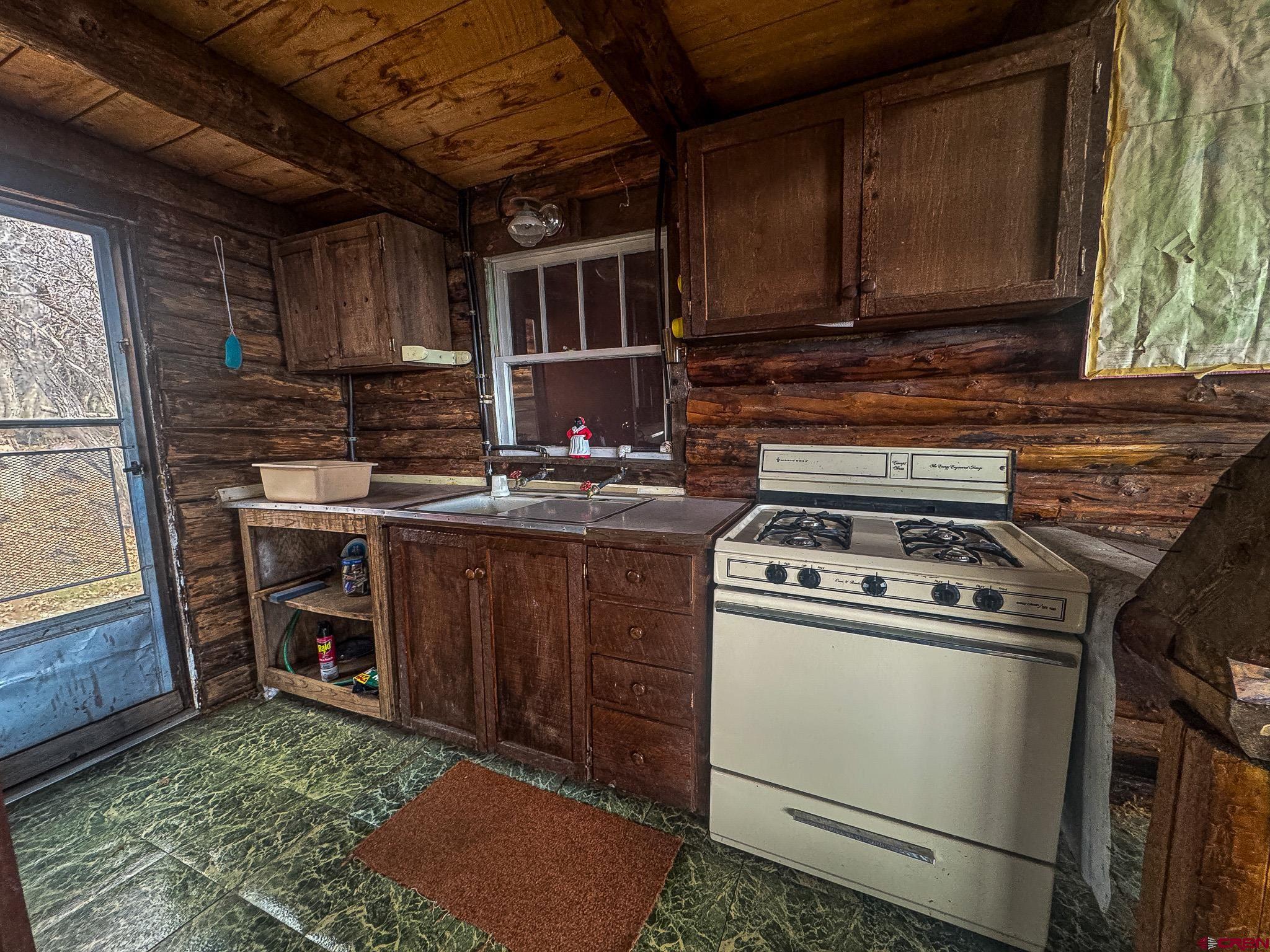 83880 Elk Rdg Trail Crawford, CO 81415 - Photo 29 of 34 a kitchen with a stove and a refrigerator