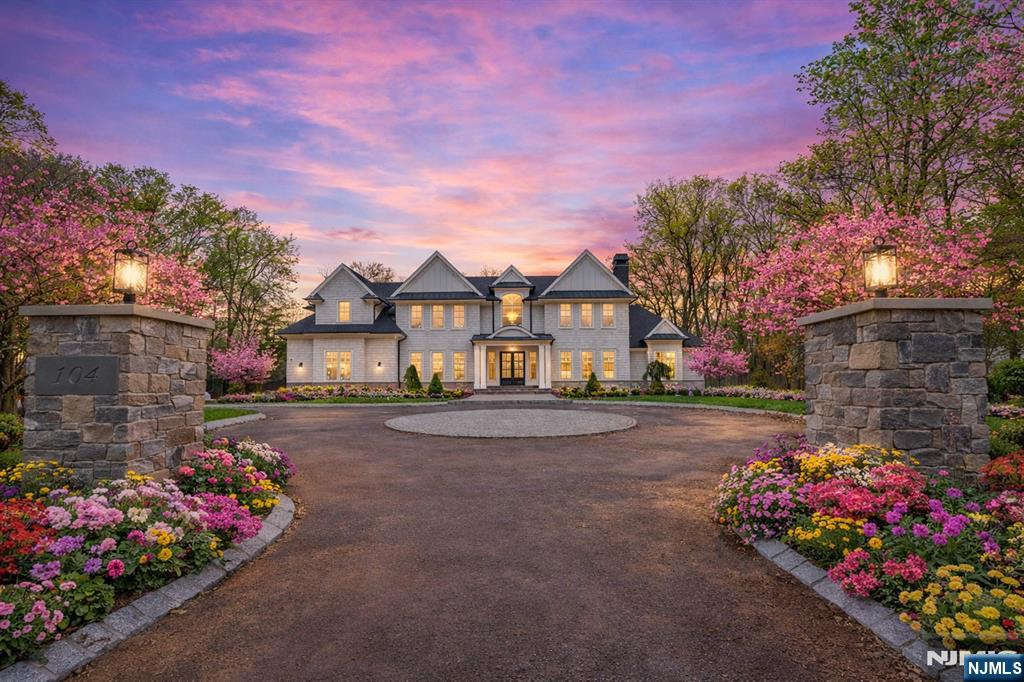 a front view of a house with a yard and a garden