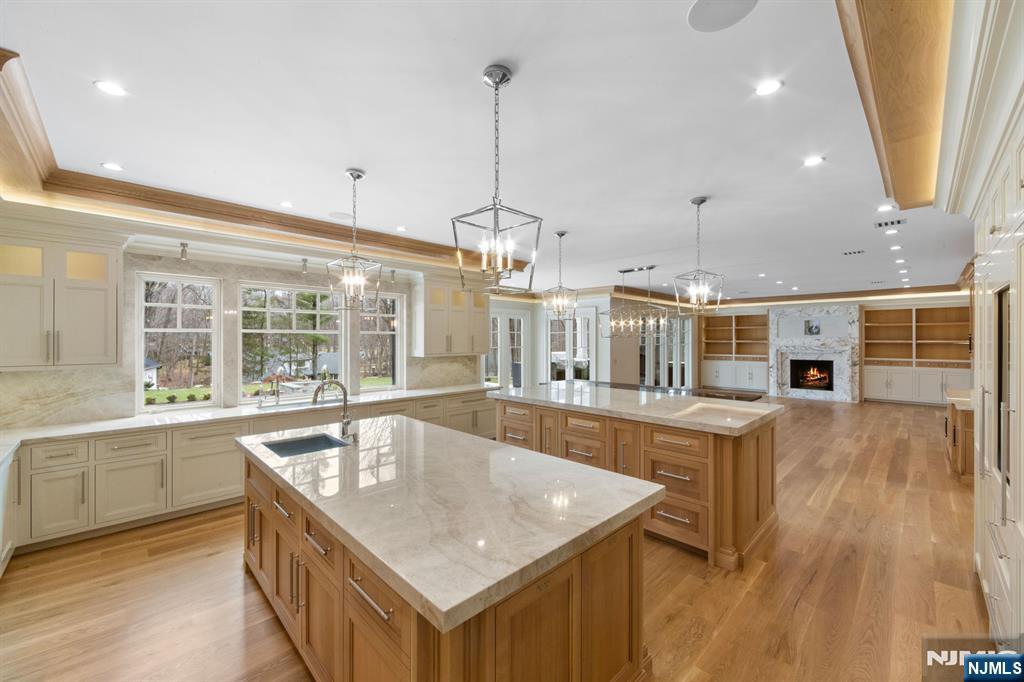 104 Chestnut Ridge Road Saddle River, NJ 07458 - Photo 11 of 47 a dining hall with stainless steel appliances granite countertop a sink a counter space and wooden floor