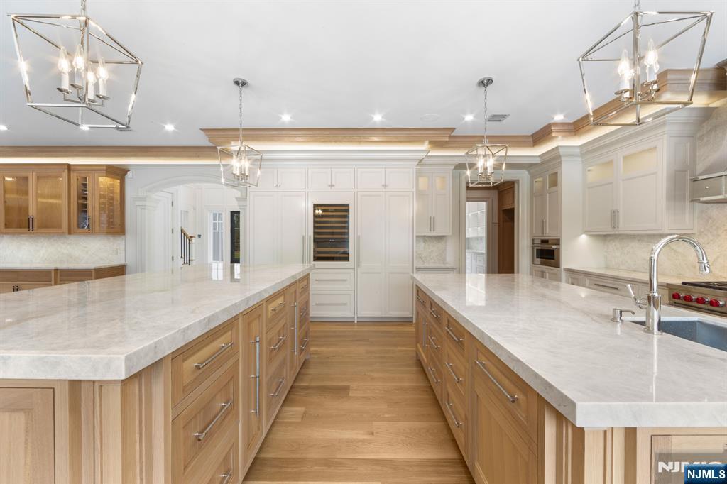 104 Chestnut Ridge Road Saddle River, NJ 07458 - Photo 13 of 47 a bathroom with a double vanity sink and a mirror