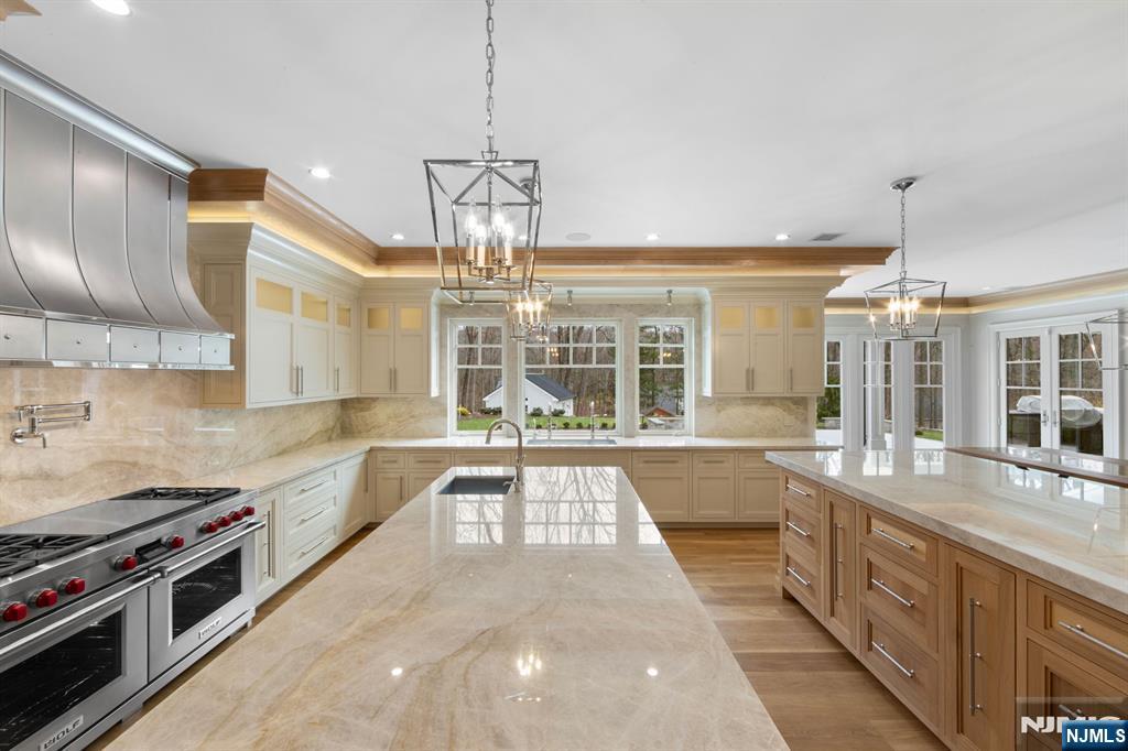 104 Chestnut Ridge Road Saddle River, NJ 07458 - Photo 14 of 47 a large kitchen with stainless steel appliances granite countertop a stove and large cabinets