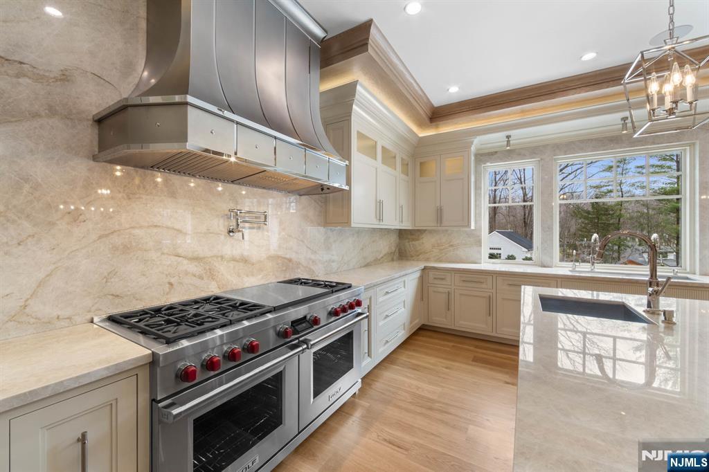 104 Chestnut Ridge Road Saddle River, NJ 07458 - Photo 15 of 47 a kitchen with stainless steel appliances a stove a sink and a refrigerator