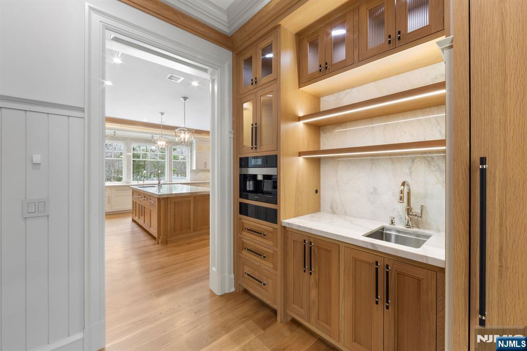 104 Chestnut Ridge Road Saddle River, NJ 07458 - Photo 16 of 47 a bathroom with a double vanity sink a mirror and a