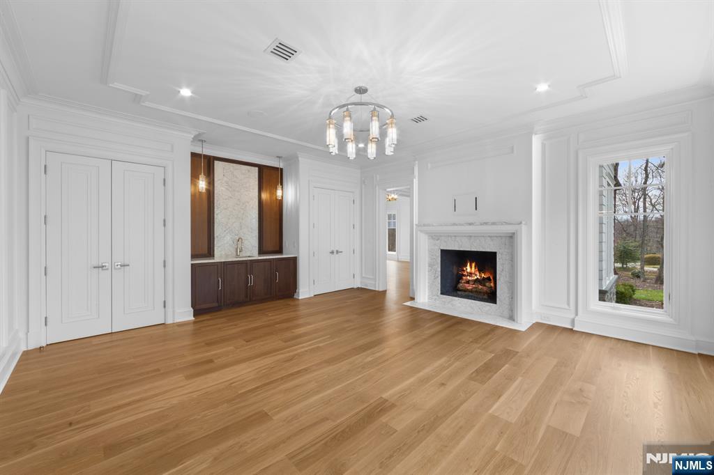 104 Chestnut Ridge Road Saddle River, NJ 07458 - Photo 19 of 47 a view of an empty room with wooden floor fireplace and a window