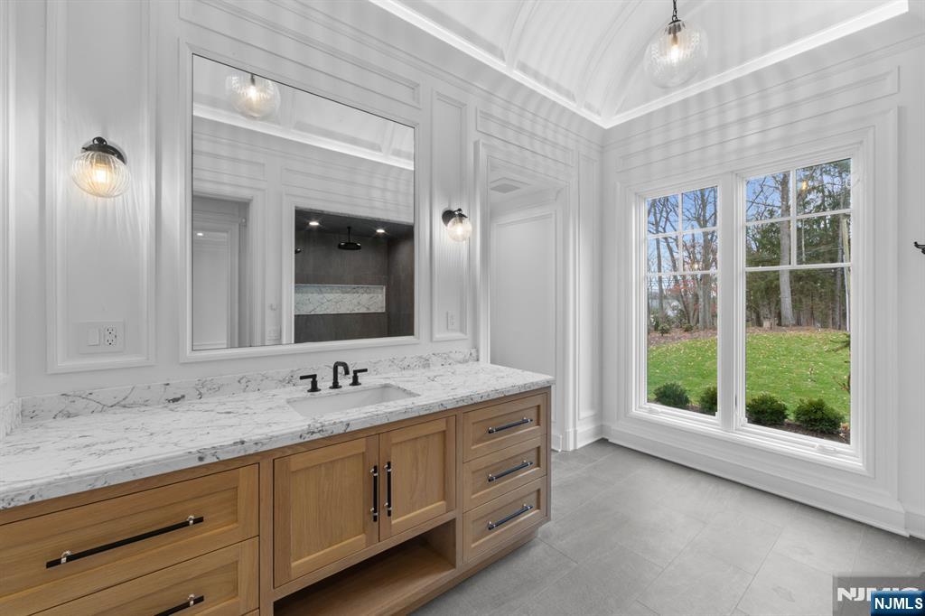 104 Chestnut Ridge Road Saddle River, NJ 07458 - Photo 21 of 47 a bathroom with a granite countertop sink mirror and window