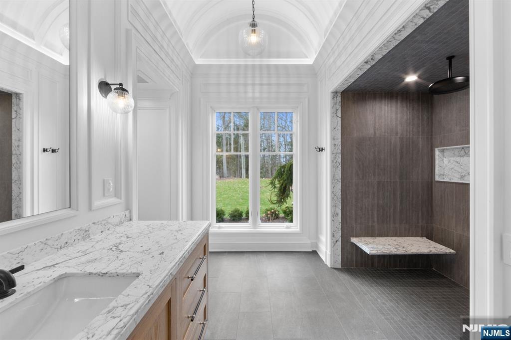 104 Chestnut Ridge Road Saddle River, NJ 07458 - Photo 22 of 47 a bathroom with a granite countertop sink a toilet and shower