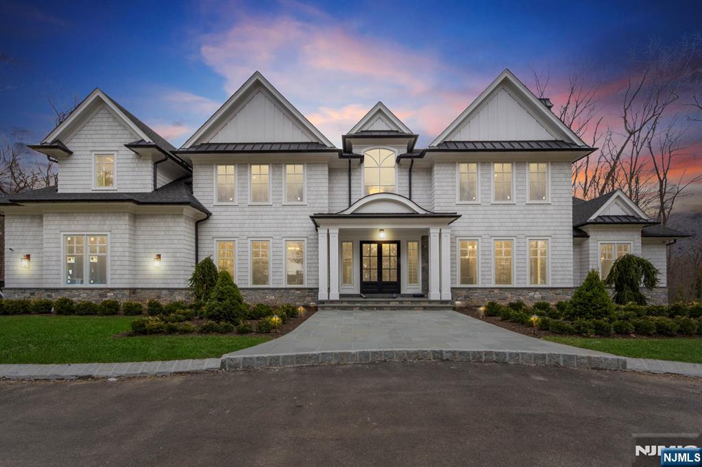 104 Chestnut Ridge Road Saddle River, NJ 07458 - Photo 3 of 47 a front view of a house with a yard and garage