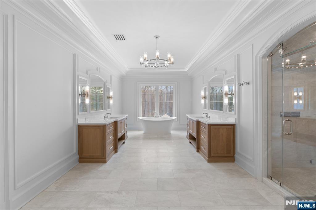 104 Chestnut Ridge Road Saddle River, NJ 07458 - Photo 32 of 47 a large white room with windows and chandelier