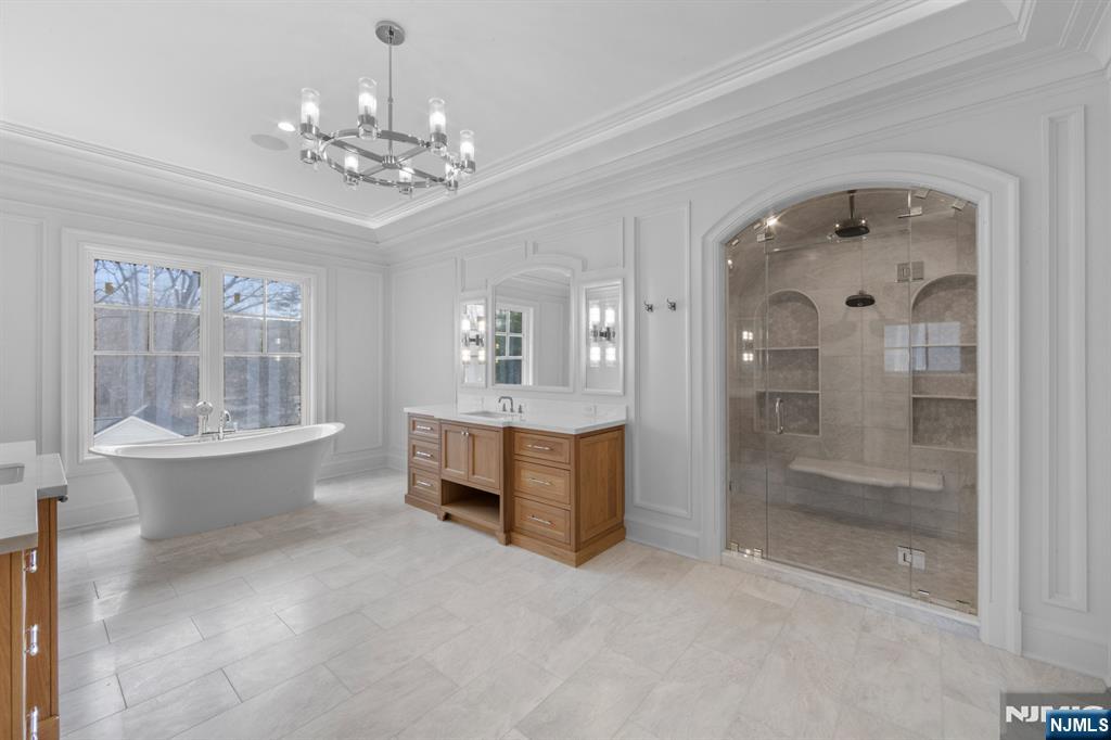 104 Chestnut Ridge Road Saddle River, NJ 07458 - Photo 33 of 47 a spacious bathroom with a double vanity sink a mirror and a bathtub