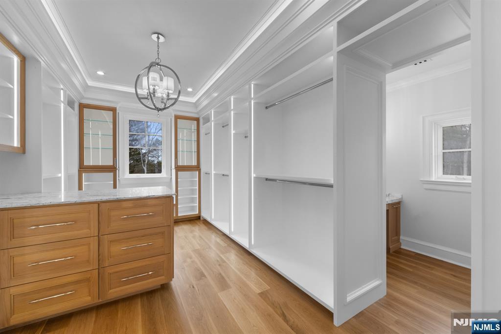 104 Chestnut Ridge Road Saddle River, NJ 07458 - Photo 36 of 47 a view of a hallway with wooden floor and chandelier