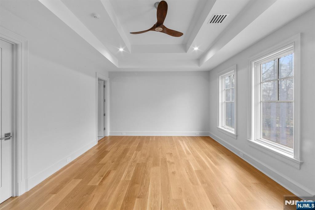 104 Chestnut Ridge Road Saddle River, NJ 07458 - Photo 41 of 47 a view of empty room with wooden floor and fan