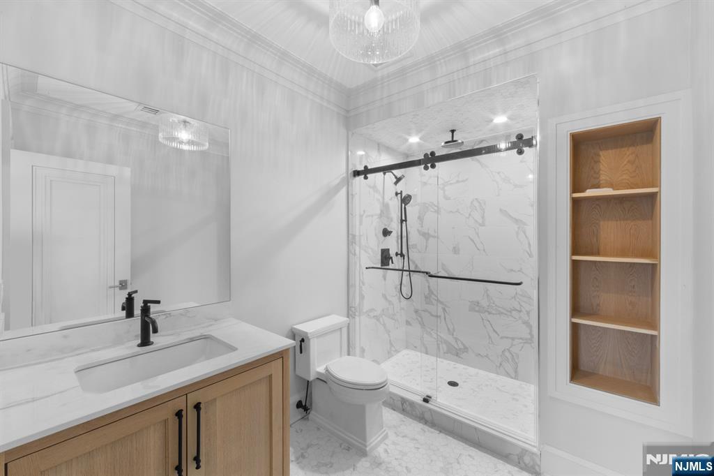 104 Chestnut Ridge Road Saddle River, NJ 07458 - Photo 46 of 47 a bathroom with a granite countertop sink toilet and shower