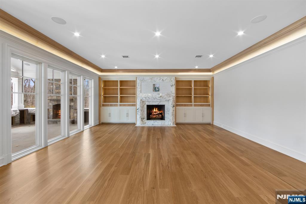104 Chestnut Ridge Road Saddle River, NJ 07458 - Photo 10 of 47 a view of an empty room with wooden floor and a fireplace
