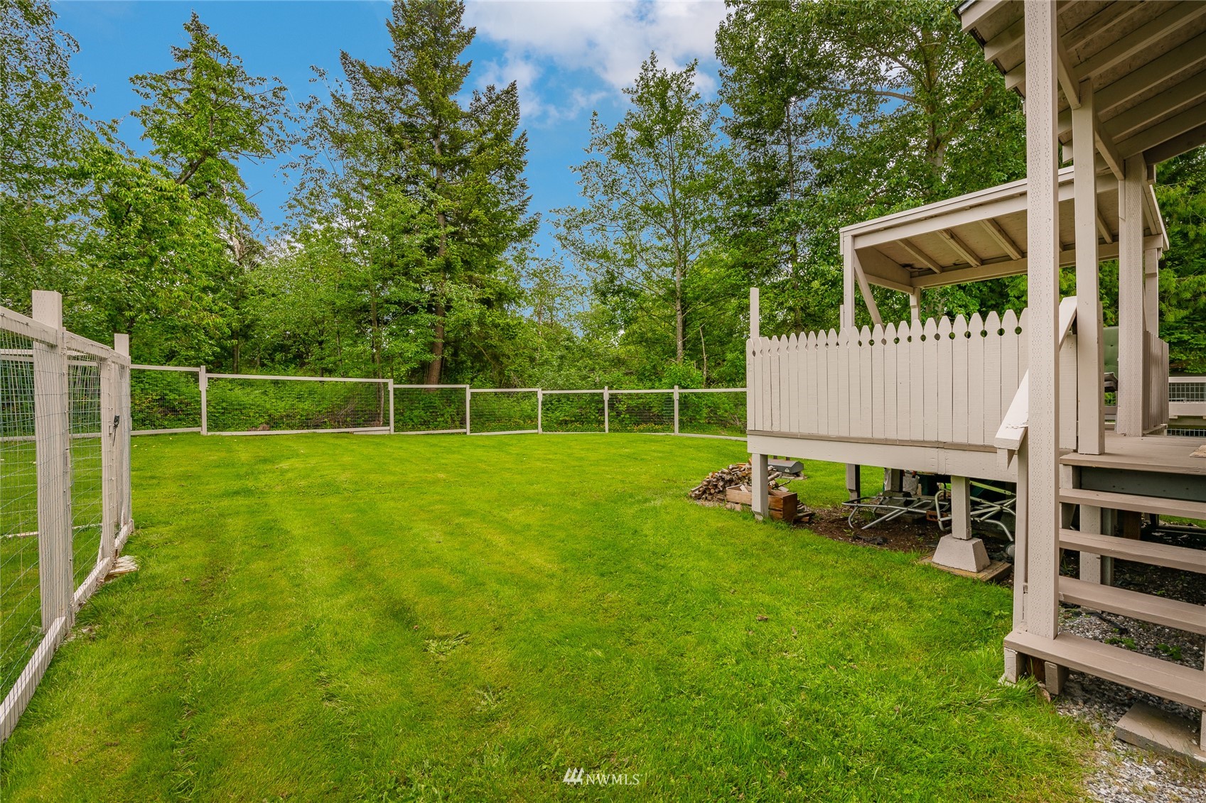 5577 E Road Bellingham, WA 98226 - Photo 11 of 40 a view of a backyard with table and chairs and wooden fence