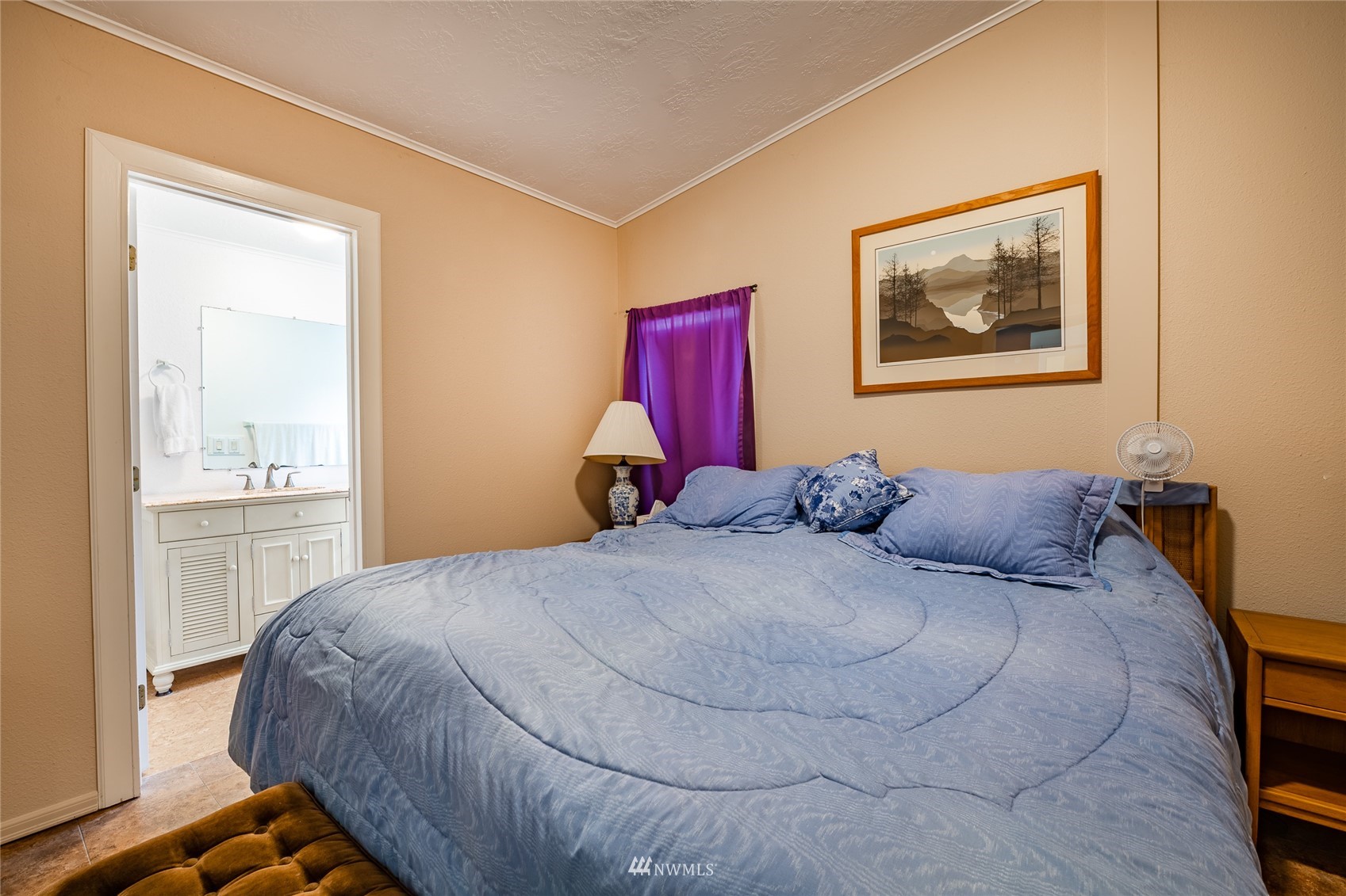 5577 E Road Bellingham, WA 98226 - Photo 16 of 40 a bed sitting in a bedroom next to a window