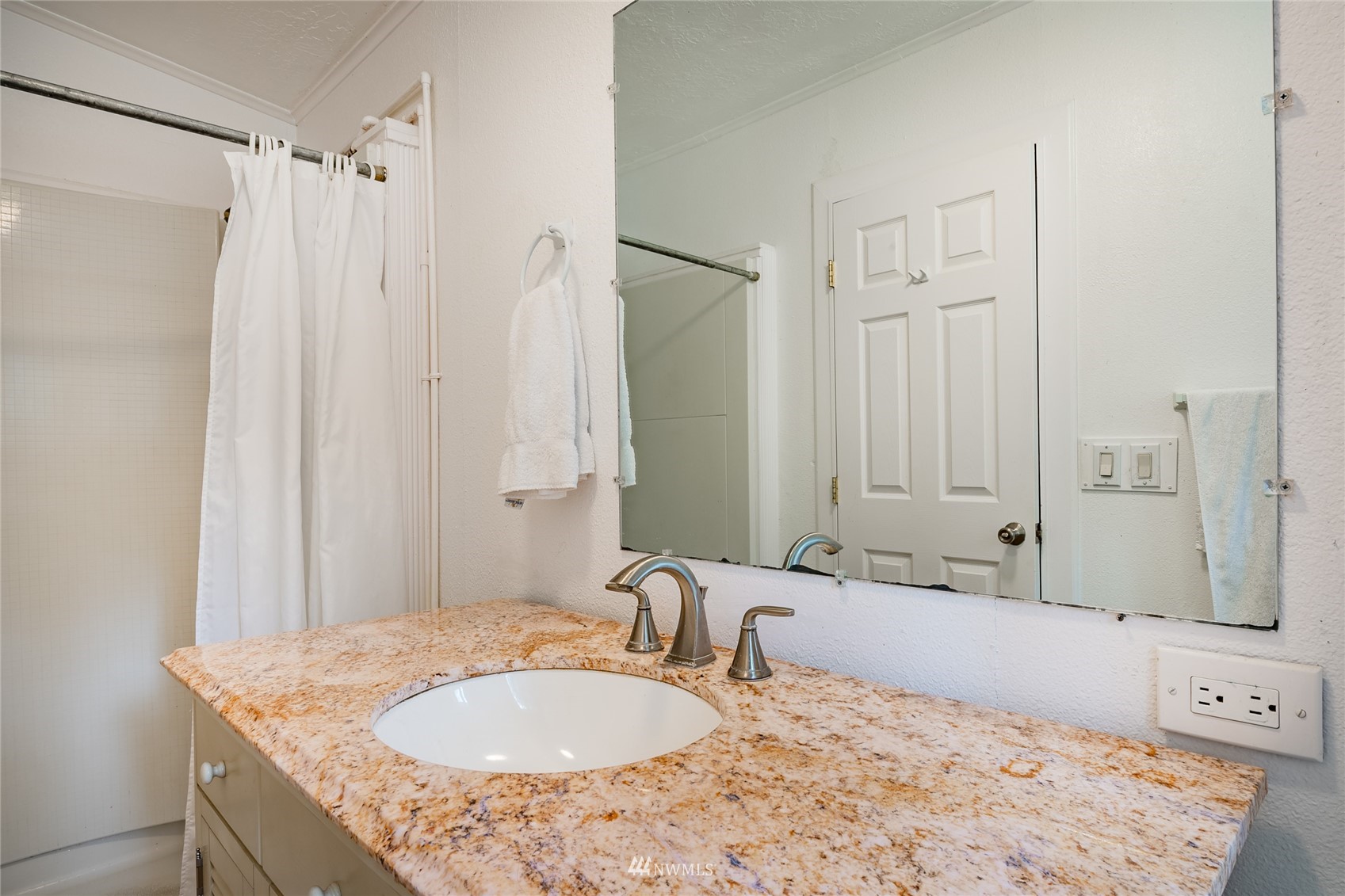 5577 E Road Bellingham, WA 98226 - Photo 17 of 40 a bathroom with a granite countertop sink a mirror and a shower