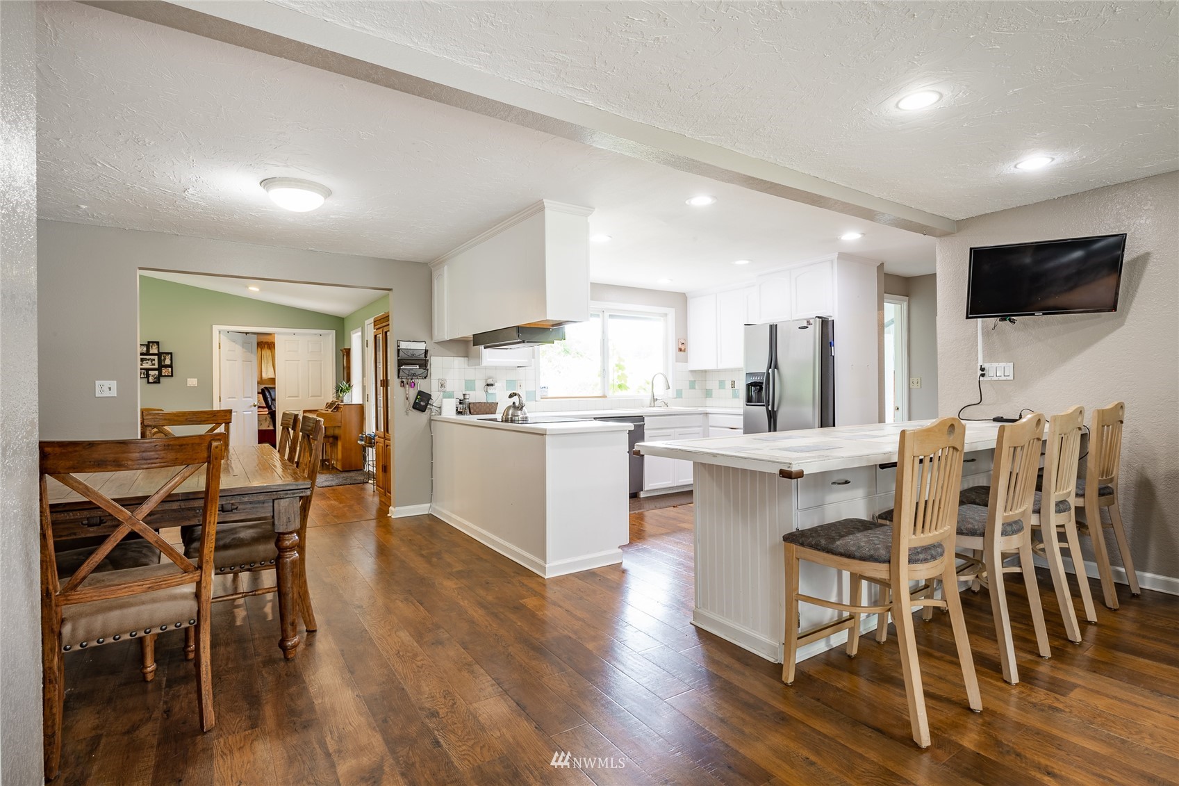 5577 E Road Bellingham, WA 98226 - Photo 35 of 40 a kitchen with stainless steel appliances kitchen island granite countertop wooden floor and white cabinets
