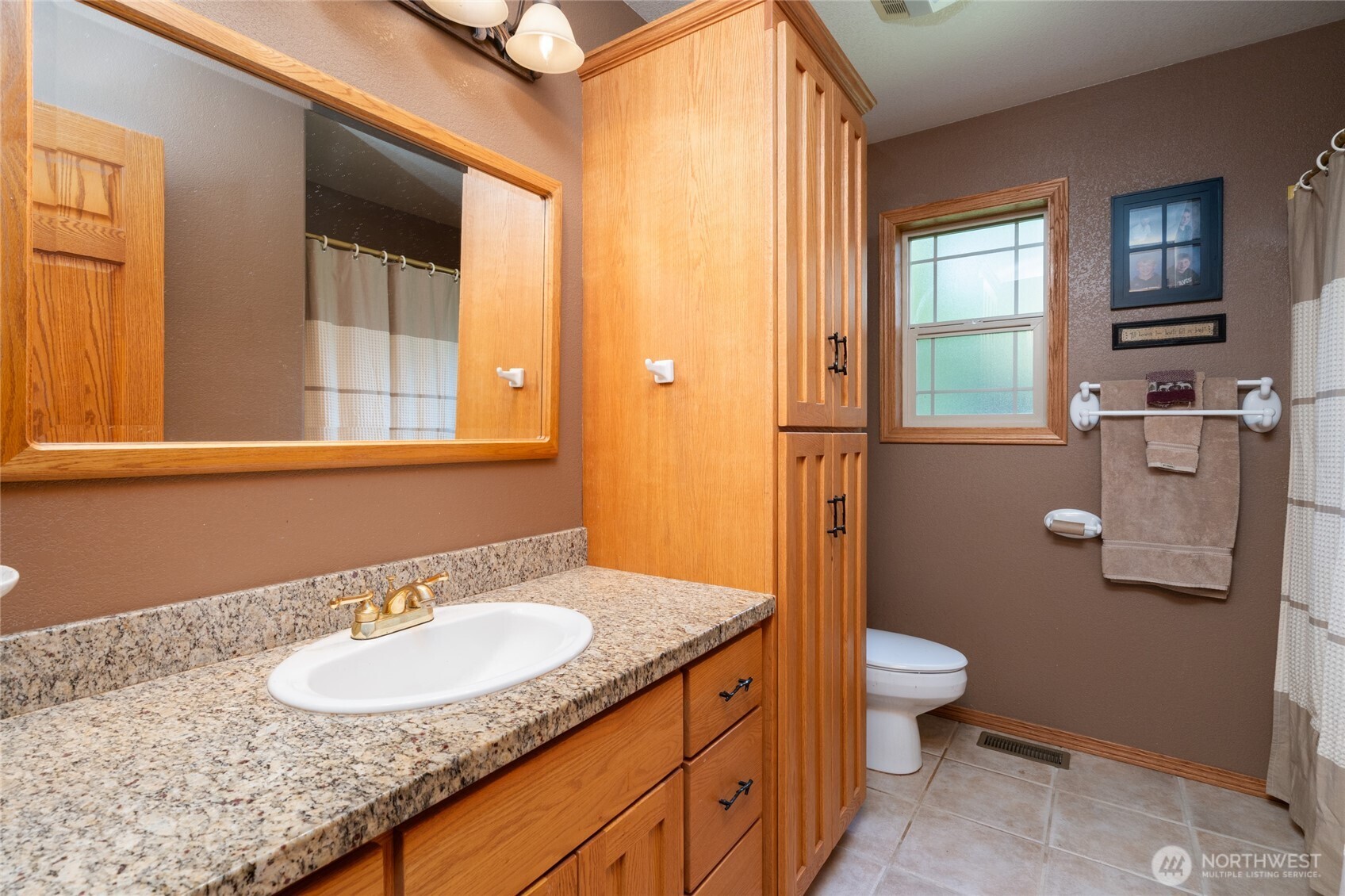 7492 Russell Road Concrete, WA 98237 - Photo 21 of 40 a bathroom with a granite countertop sink and a mirror