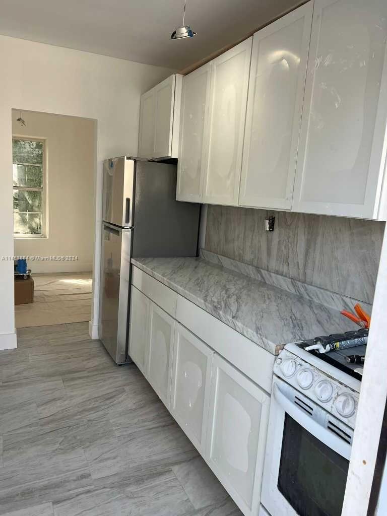 6955 Rue Vendome Miami Beach, FL 33141 - Photo 12 of 43 a kitchen with a refrigerator sink and cabinets