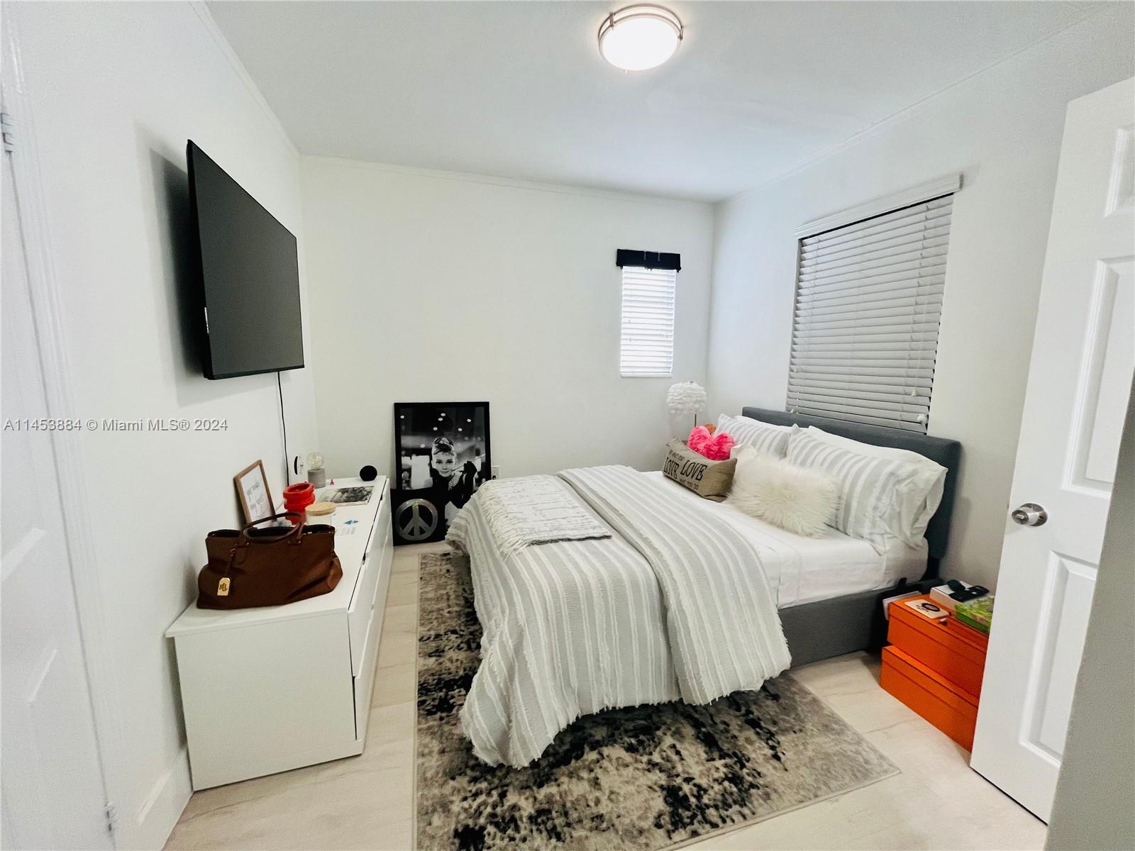 6955 Rue Vendome Miami Beach, FL 33141 - Photo 17 of 43 a bedroom with a bed and a flat screen tv