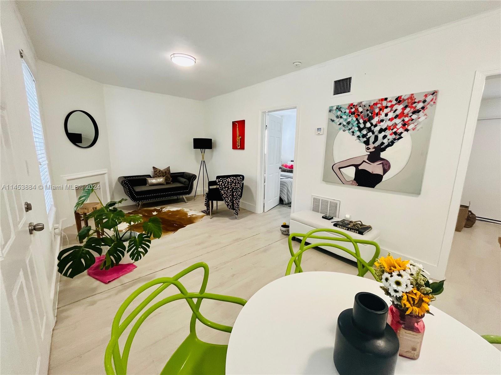 6955 Rue Vendome Miami Beach, FL 33141 - Photo 20 of 43 a bathroom with a sink mirror and flowers