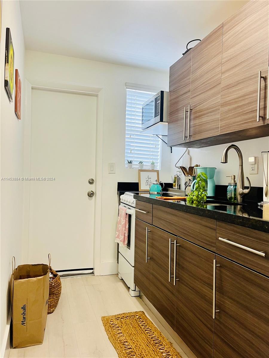 6955 Rue Vendome Miami Beach, FL 33141 - Photo 22 of 43 a kitchen with stainless steel appliances granite countertop a sink and cabinets