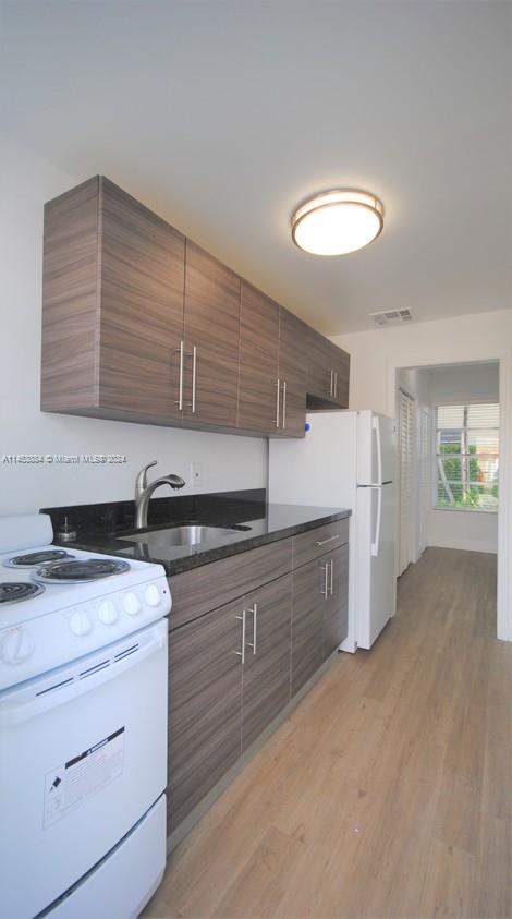 6955 Rue Vendome Miami Beach, FL 33141 - Photo 25 of 43 a kitchen that has a sink and cabinets