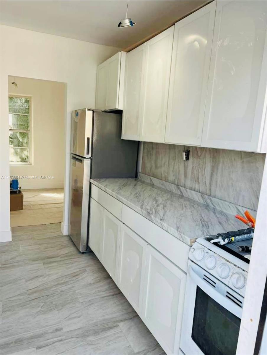 6955 Rue Vendome Miami Beach, FL 33141 - Photo 26 of 43 a kitchen with a refrigerator sink and cabinets