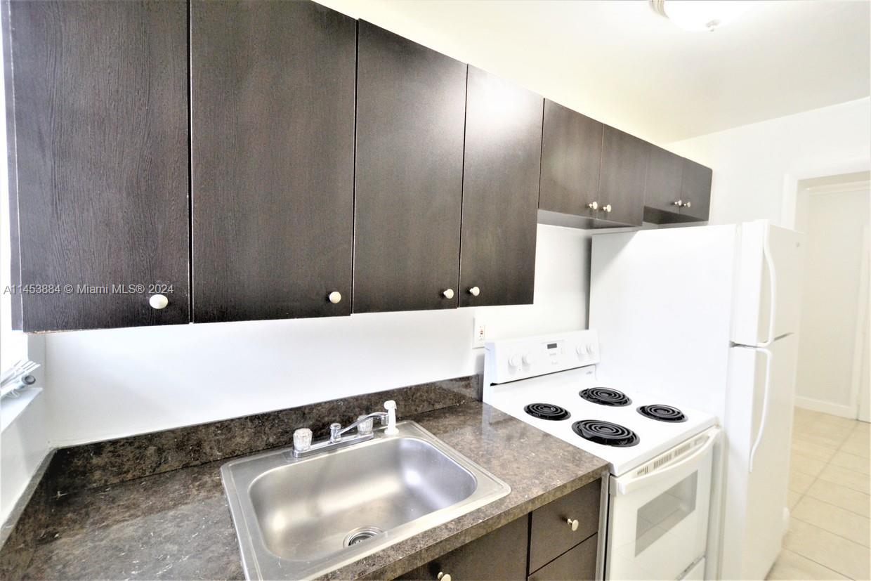 6955 Rue Vendome Miami Beach, FL 33141 - Photo 28 of 43 a bathroom with a sink and a mirror