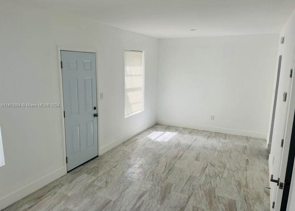 6955 Rue Vendome Miami Beach, FL 33141 - Photo 35 of 43 an empty room with wooden floor and windows