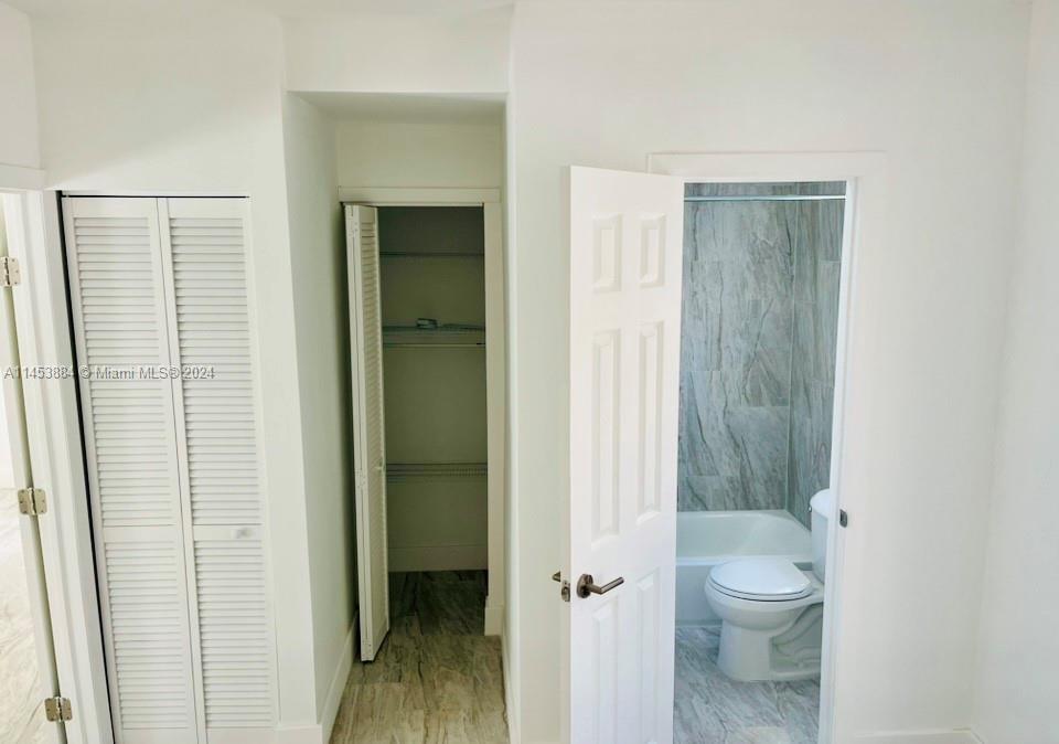 6955 Rue Vendome Miami Beach, FL 33141 - Photo 38 of 43 a bathroom with a granite countertop toilet a sink and shower