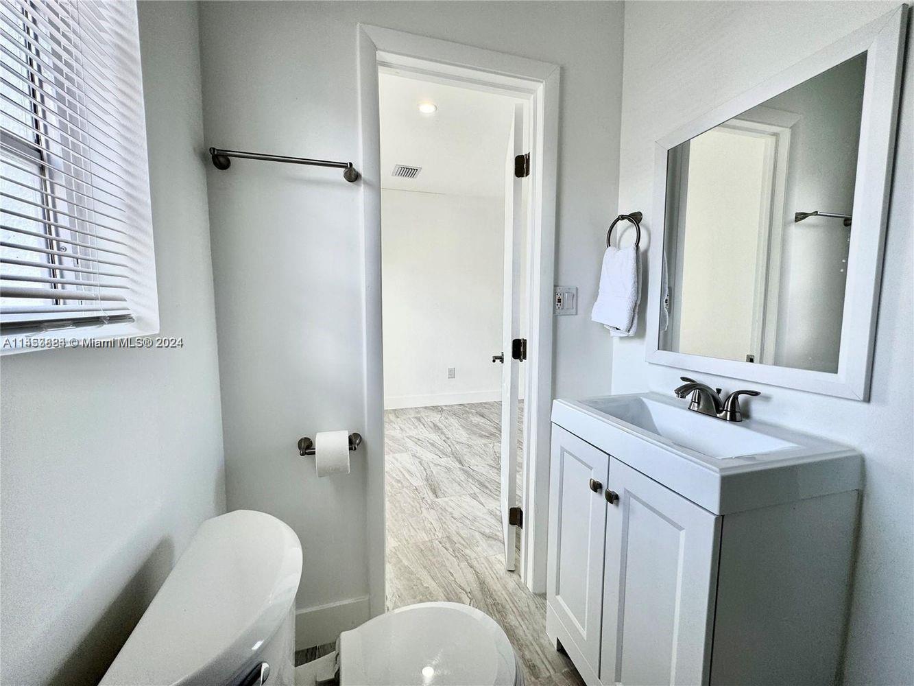 6955 Rue Vendome Miami Beach, FL 33141 - Photo 43 of 43 a bathroom with a granite countertop sink toilet and shower