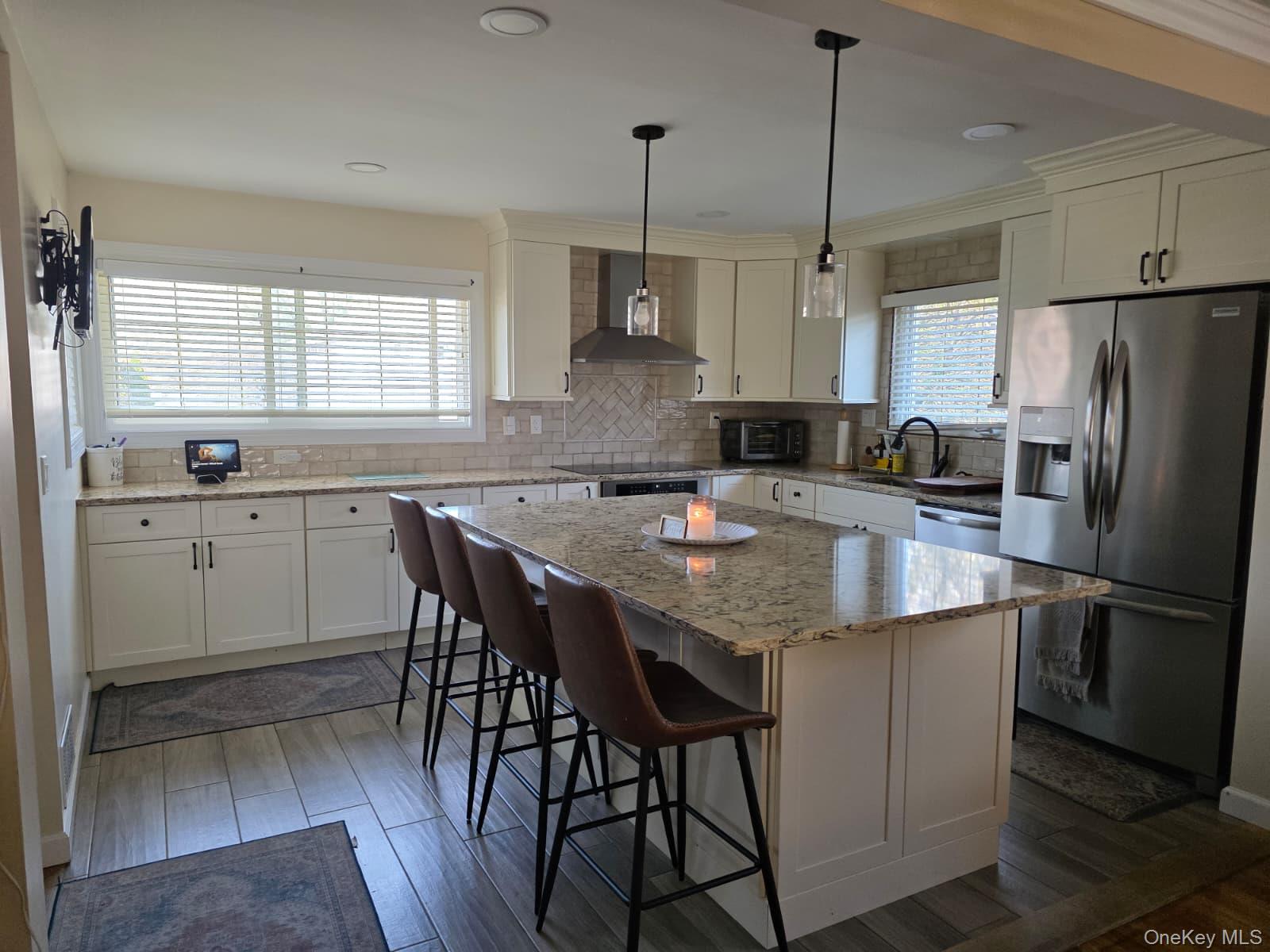 838 Pepperidge Road Westbury, NY 11590 - Photo 4 of 13 a kitchen with stainless steel appliances granite countertop a sink a stove a refrigerator and island