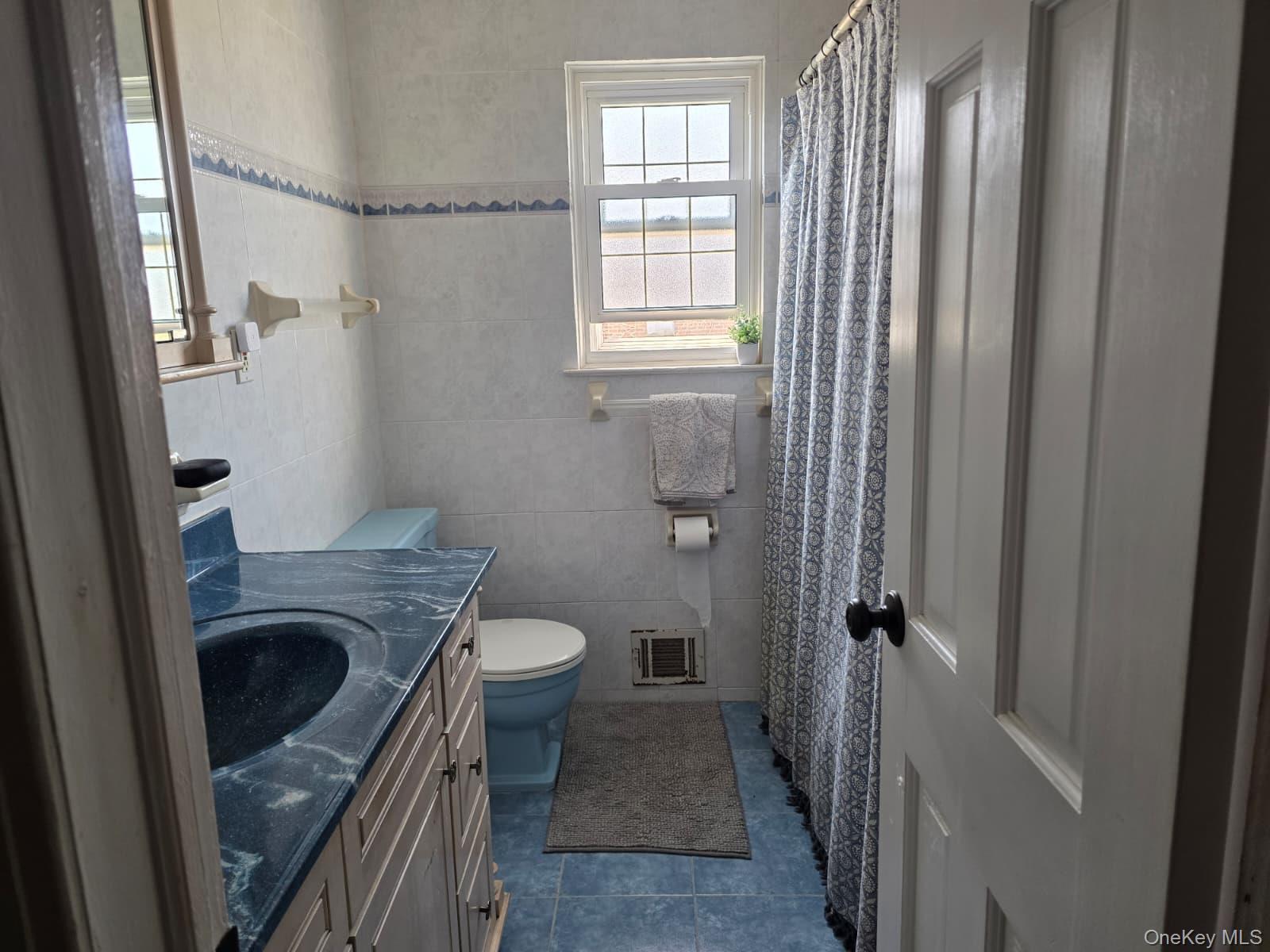 838 Pepperidge Road Westbury, NY 11590 - Photo 10 of 13 a bathroom with a sink a toilet and shower