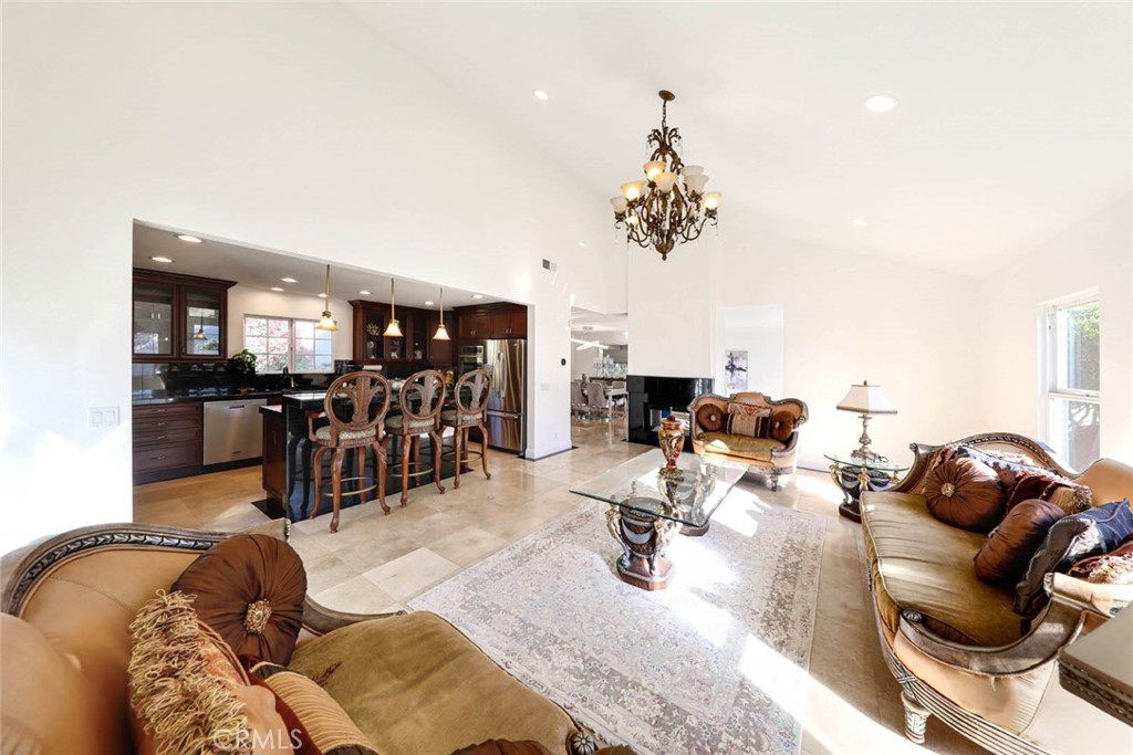 20975 Sequoia Lane Mission Viejo, CA 92691 - Photo 12 of 47 a living room with furniture a chandelier and a wooden floor