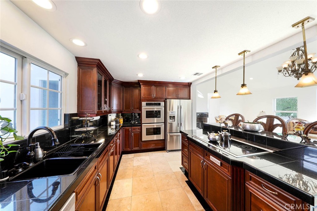 20975 Sequoia Lane Mission Viejo, CA 92691 - Photo 15 of 47 a kitchen with lots of counter top space and stainless steel appliances