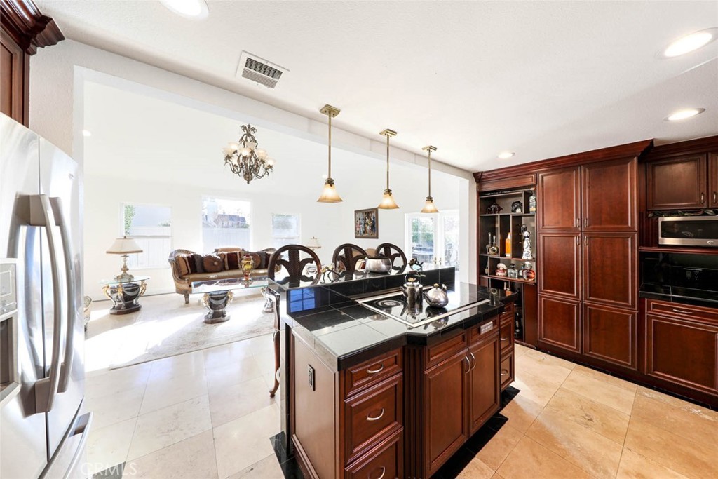 20975 Sequoia Lane Mission Viejo, CA 92691 - Photo 16 of 47 a kitchen with stainless steel appliances granite countertop a stove refrigerator and cabinets