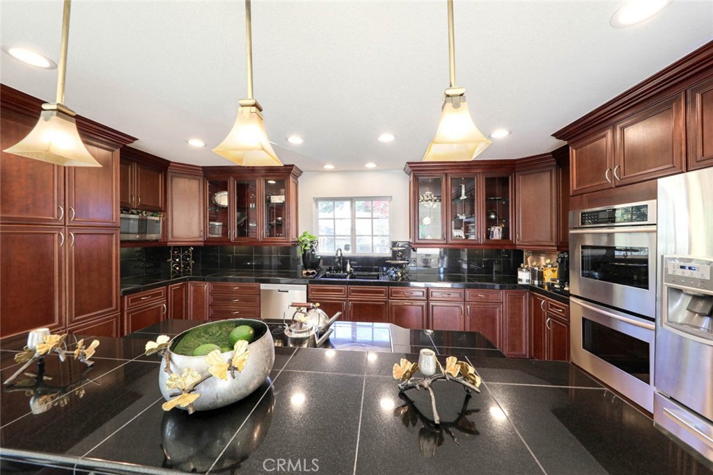 20975 Sequoia Lane Mission Viejo, CA 92691 - Photo 17 of 47 a kitchen with sink refrigerator and cabinets