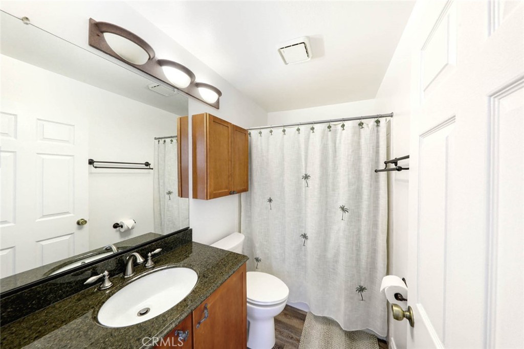 20975 Sequoia Lane Mission Viejo, CA 92691 - Photo 28 of 47 a bathroom with a granite countertop sink toilet a mirror and shower