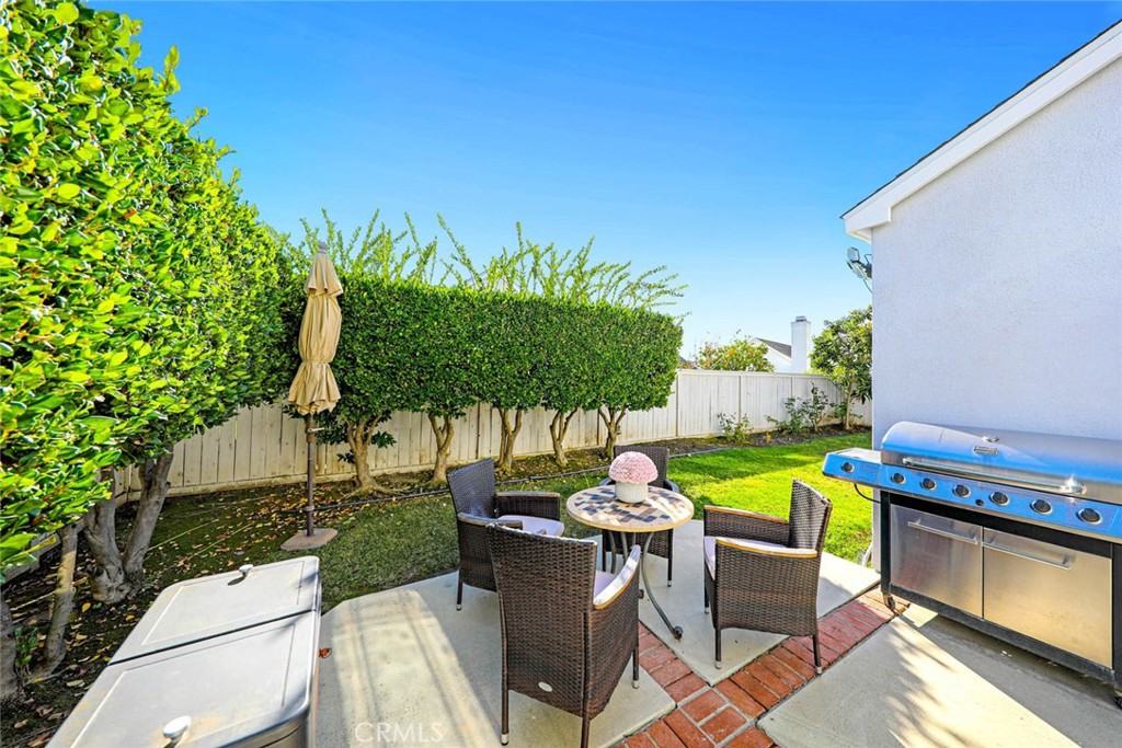 20975 Sequoia Lane Mission Viejo, CA 92691 - Photo 35 of 47 a view of a patio with table and chairs potted plants and palm tree
